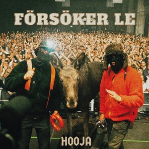 Försöker le