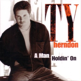 A Man Holdin' On (To A Woman Lettin' Go)